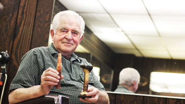 Barber and fishing tackle hobbyist Shorty Mueller shows off a few of his custom-made rod handles.
