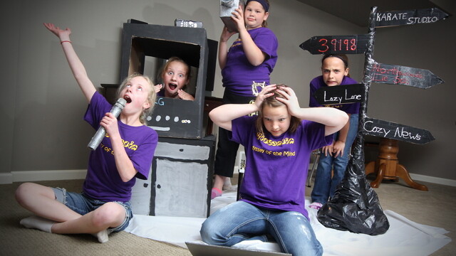 The fifth graders of Northwoods Elementary’s OM team rehearse with part of the set they designed and built for competition. They’re headed to a global tournament in late May.