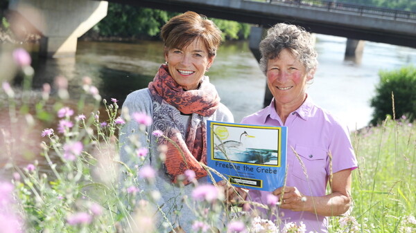 BEAUTIFUL DAY FOR A BOOK ABOUT STORMS. Mary Gladitsh (left) illustrated Karen Wise’s (right) children’s book, Freebee the Grebe, which stresses the importance of storms to the Earth’s environment.