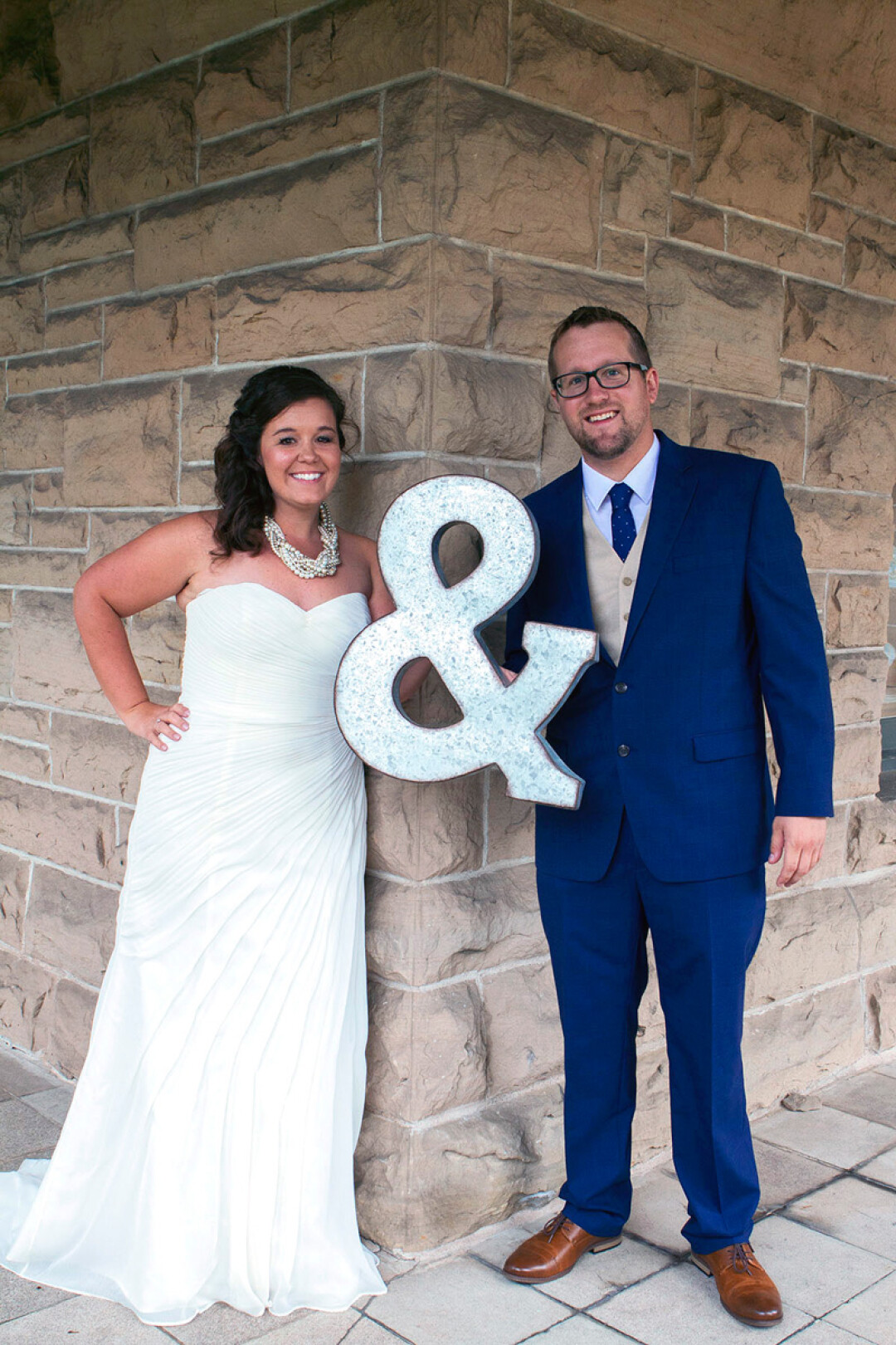 Kira and Mike Sullivan pose on the porch of the Louis Smith Tainter House at UW-Stout on their wedding day, Aug. 20. The couple met on campus in 2009 and were married at the student center.