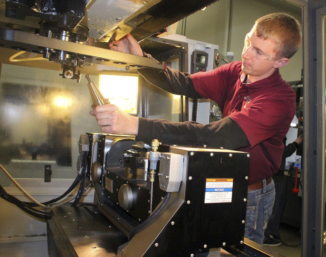 A Chippewa Valley Technical College student operates a computer numerical controlled (CNC) lathe.