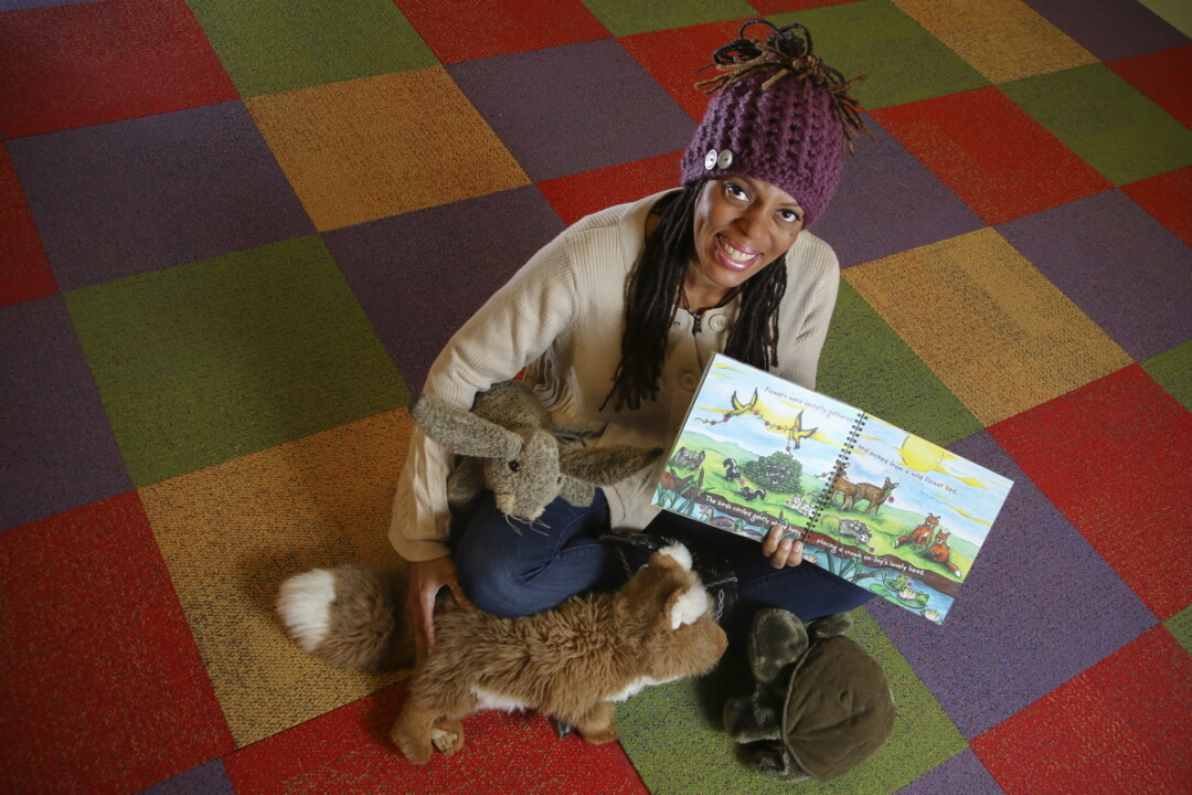 FURRY FRIENDS. Ava Gustafson (above) shows off a proof copy of her new book, which includes colorful illustrations by former Spooner art teacher Katrina Dohm (below).