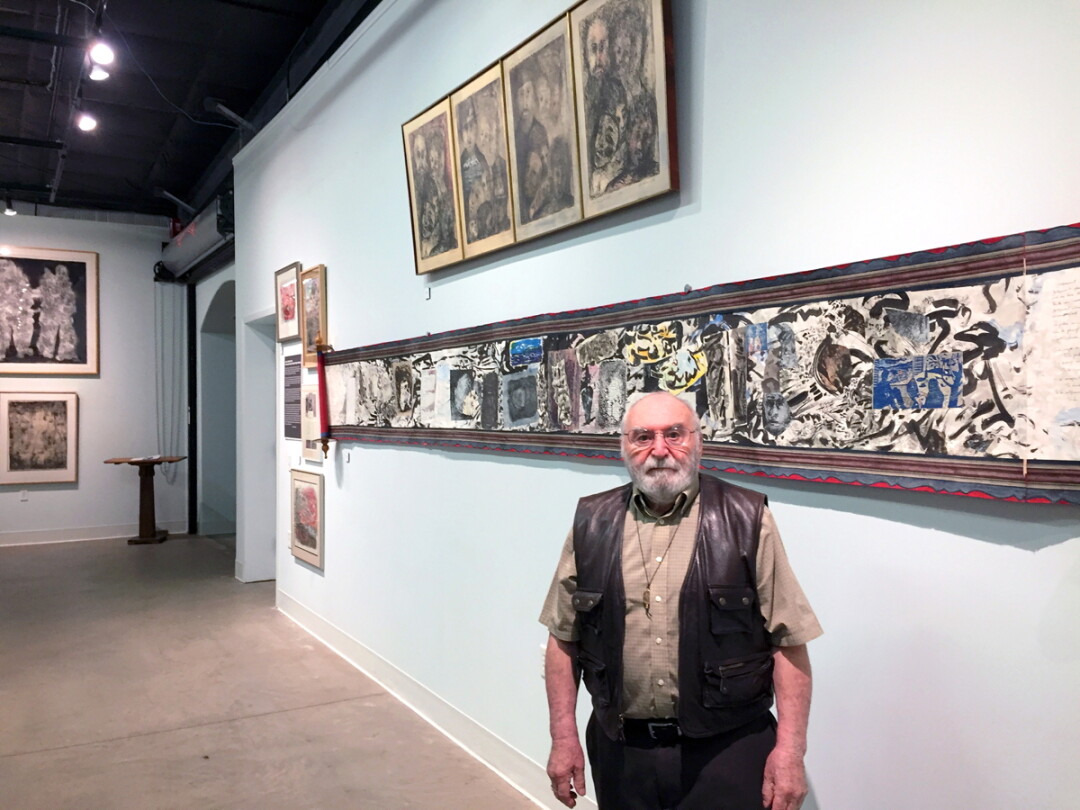 A LIFE IN ART. William Schulman, the founder of the UW-Stout art education department, creates large scroll collages, like the one on the wall behind him. An exhibit of work by Schulman and his wife, Shirley Siegel Schulman, is on display at the Rassbach Heritage Museum in Menomonie. 