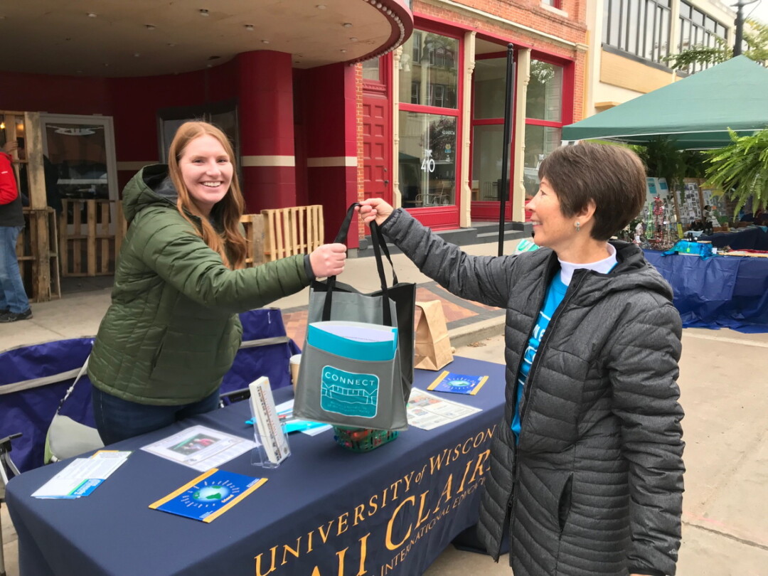 LET’S GET TOGETHER. A new organization that helps residents get to know their new-to-Eau Claire neighbors, called CONNECT, handed out gift bags at the International Fall Festival in October.