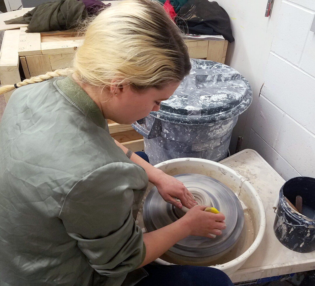 KEEP ON BOWLIN’. Sarah Bennett fashions a bowl at the potter’s wheel in her UW-Stout studio. Despite her apparent ease and grace, she points out, “It took me years and years of practice to get to this point!”