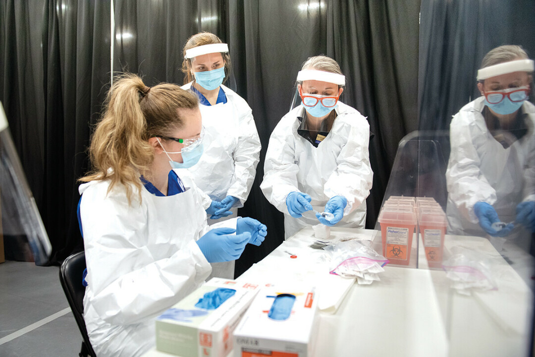 GIVING IT THEIR BEST SHOT. UW-Eau Claire nursing students and faculty worked together at the mass vaccination clinic in early 2020 at Zorn Arena.
