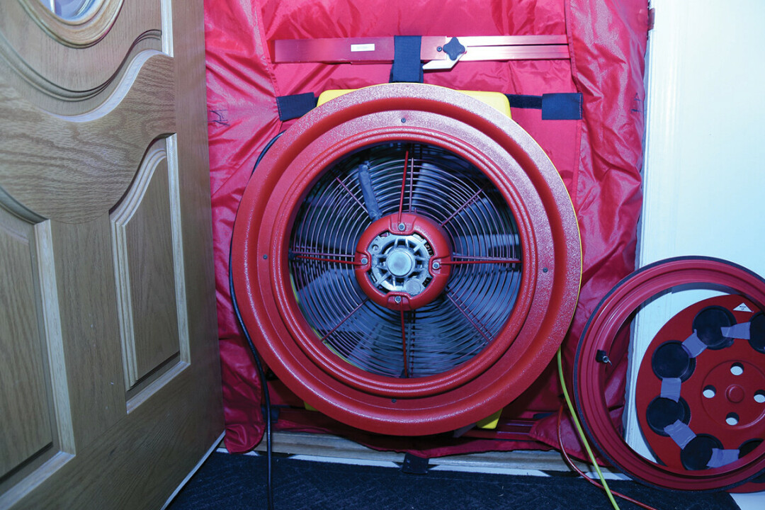 DOORWAY TO SAVINGS. A blower door test during a home energy audit. (Photo by EE 