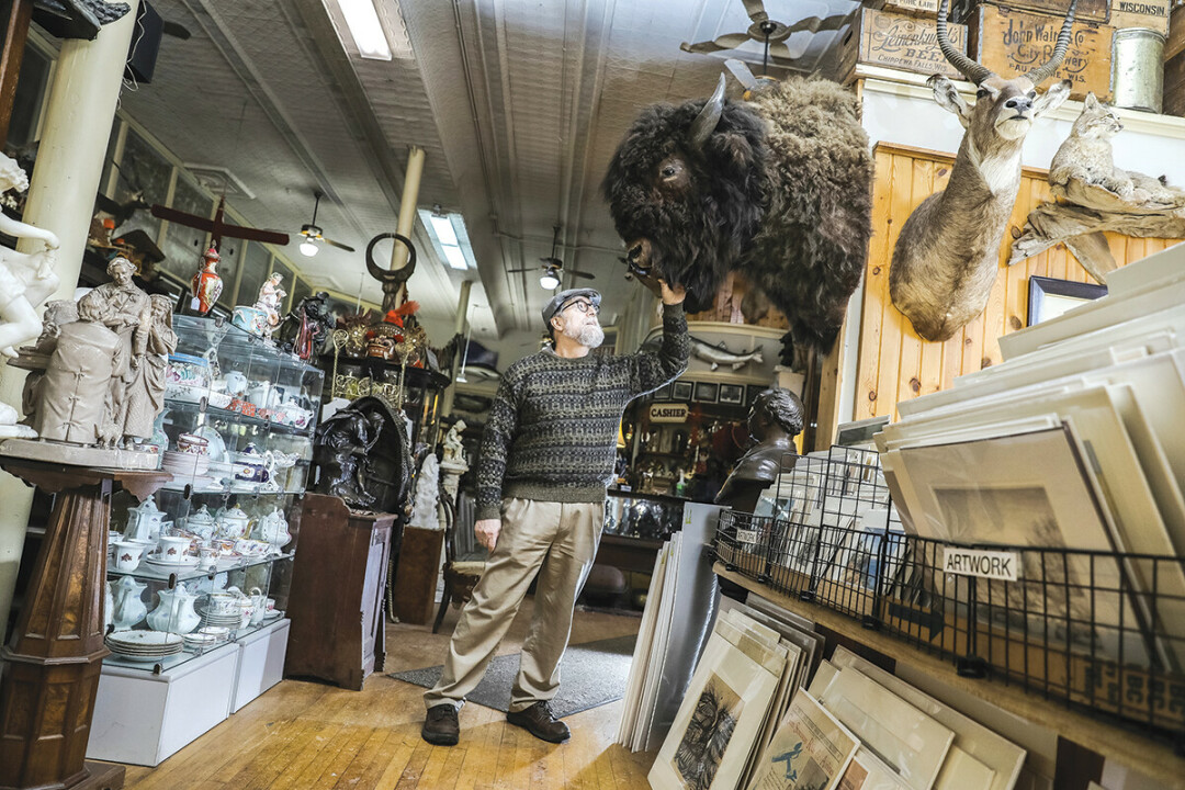 HOW MUCH IS THAT BISON IN THE WINDOW? Hugh Passow is in the midst of downsizing downtown Eau Claire's Antique Emporium in advance of a planned September auction.
