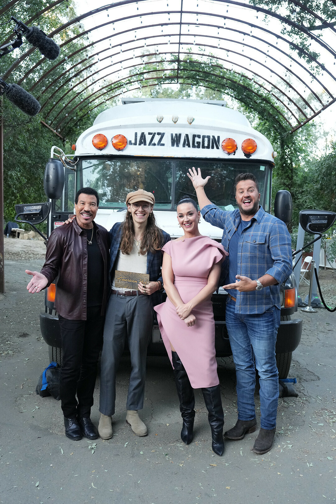 Chippewa Falls native CJ Rislove, second from left, poses with American Idol judges xxxxx in front of his bus.