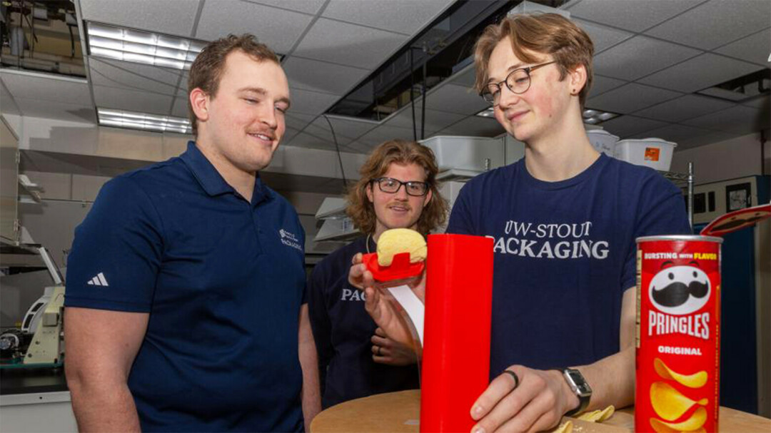 IT'S SNACKIN' TIME. UW-Stout student Ethan Myers, right, demonstrates a feature of the Pringles can that he and teammates Lukas David, left, and Zach Hoffmire designed to win a major competition. (Submitted photos) 
