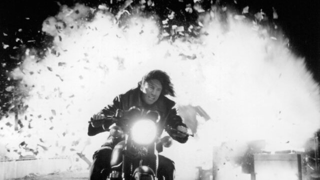 Post fireball, Keanu Reeves rides a motorbike straight into our lil' ol' Sconnie hearts in 1996's Chain Reaction.