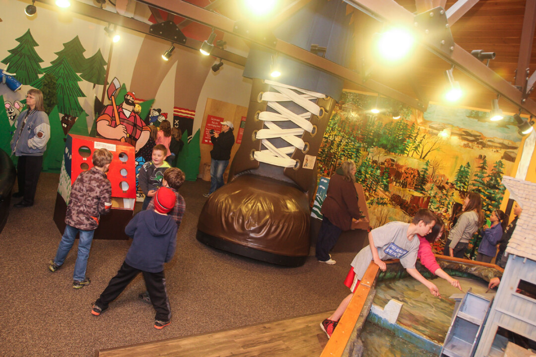 KIDS EXPLORE THE PAUL’S TALL TALES ROOm, which features hands-on exhibits and games.