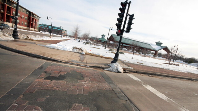 The brick pavers in the Madison Street crosswalk to Phoenix Park in downtown Eau Claire have formed potholes far earlier than expected, causing some to question their fiscal viability , despite how awesome they look.