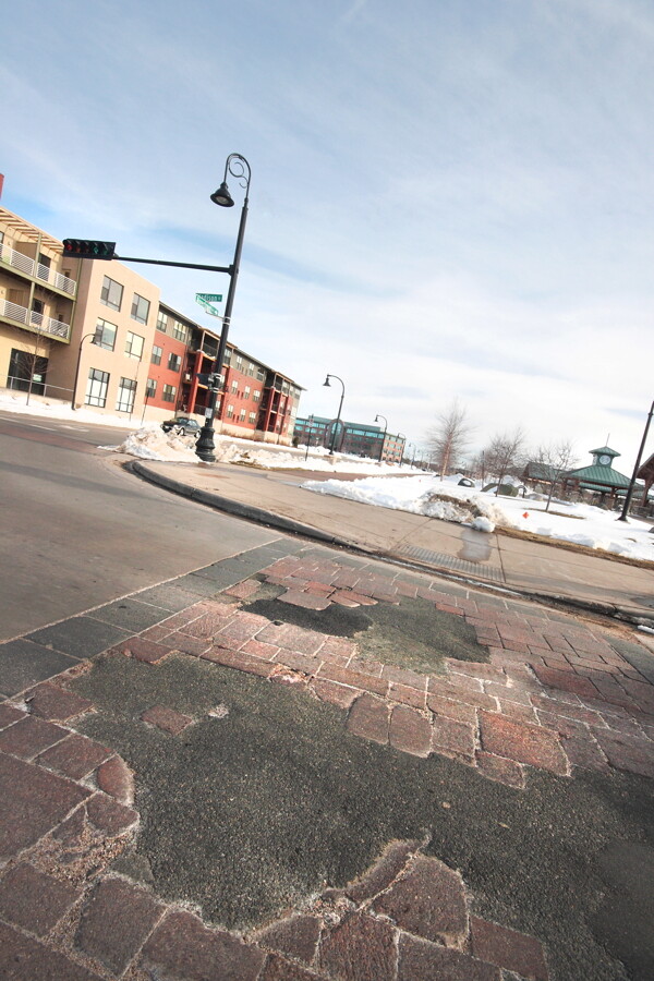 The brick pavers in the Madison Street crosswalk to Phoenix Park in downtown Eau Claire have formed potholes far earlier than expected, causing some to question their fiscal viability , despite how awesome they look.