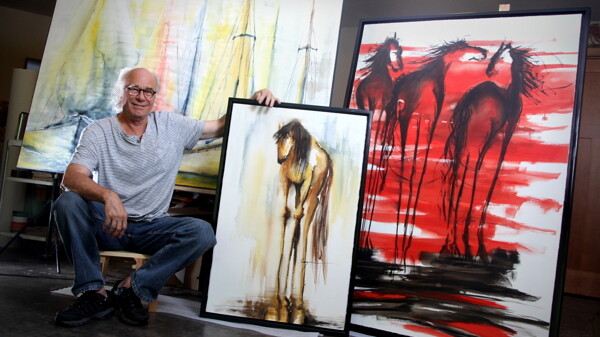 A HORSE OF A DIFFERENT COLOR. Artist Terry Meyer shows off his work in his home studio.