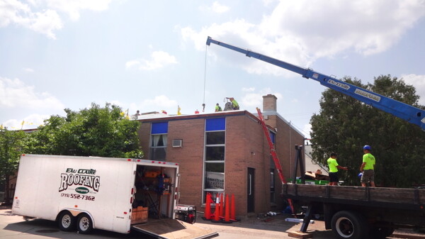 DROPPING THE CURTAIN ON THE OLD ROOF. Neighboring businesses helped the Chippewa Valley Theatre Guild pay to replace the roof on the Grand Theatre, 102 W. Grand Ave., this summer.