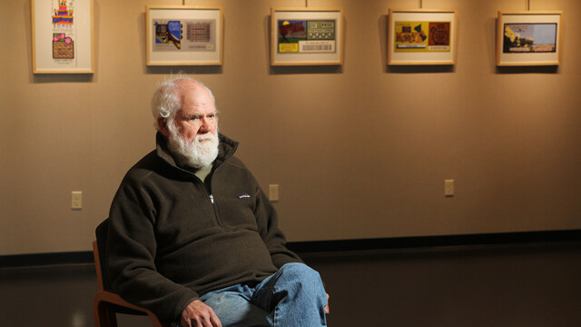 STARK CONTRAST. Eau Claire artist Larry Stark sits before some of the work he’s got hanging at the L.E. Phillips Memorial Public Library through Nov. 23.