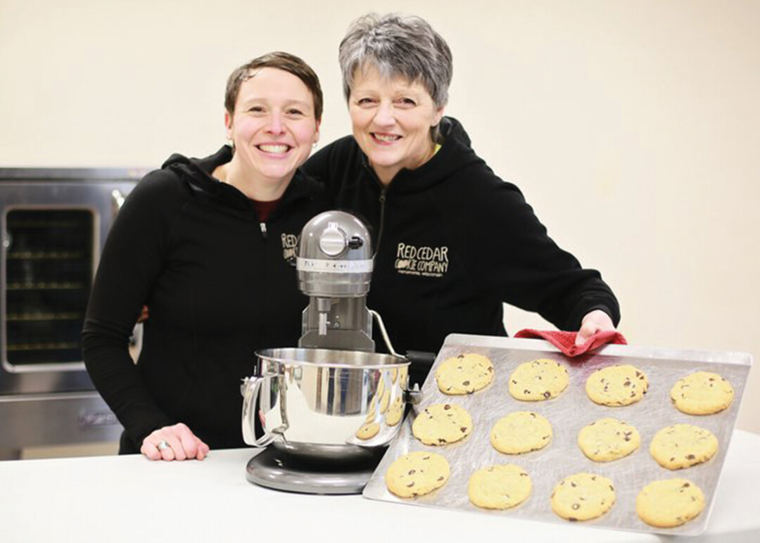 MIXING UP THE FLAVOR. Lisa Buhl, left, started the Red Cedar Cookie Co. which bakes up classic mom-approved recipes and delivers them – warm – right to your door (with ice cold milk – if you’re doing it right).