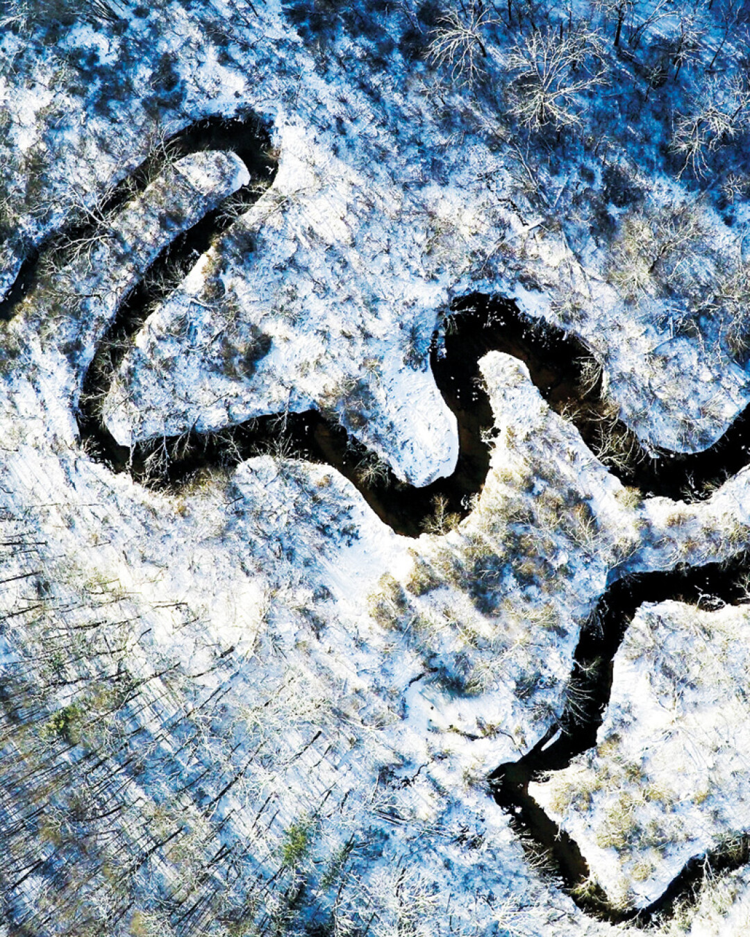 A RIVER TWISTS THROUGH IT. Part of his “Frosty Mini Series,” photographer Nick Uthe wanted to show Wisconsin from a new perspective, using a drone to capture some local landscape at Lowes Creek County Park, shown here. Uthe says, “This was a small tribute to the state I love.” Instagram: @nickuthe