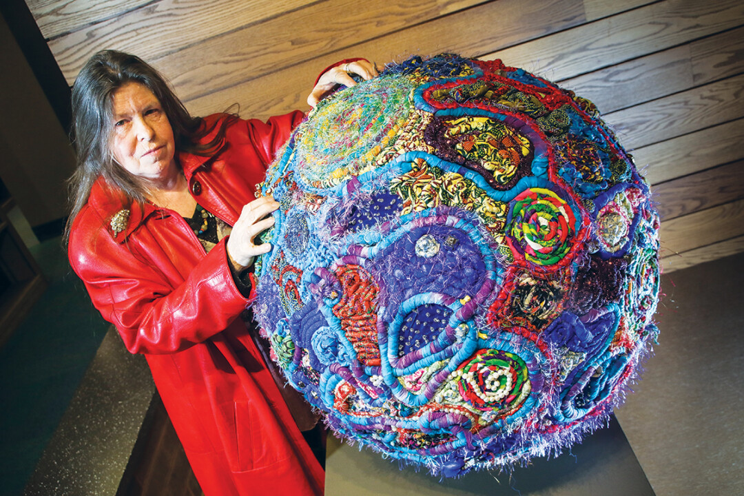 WANTED: THREAD OR ALIVE. Local artist Paula Gorski and her piece “Primordial Memory Form 5,” which won Best In Show in the 39th annual ArtsWest exhibition.