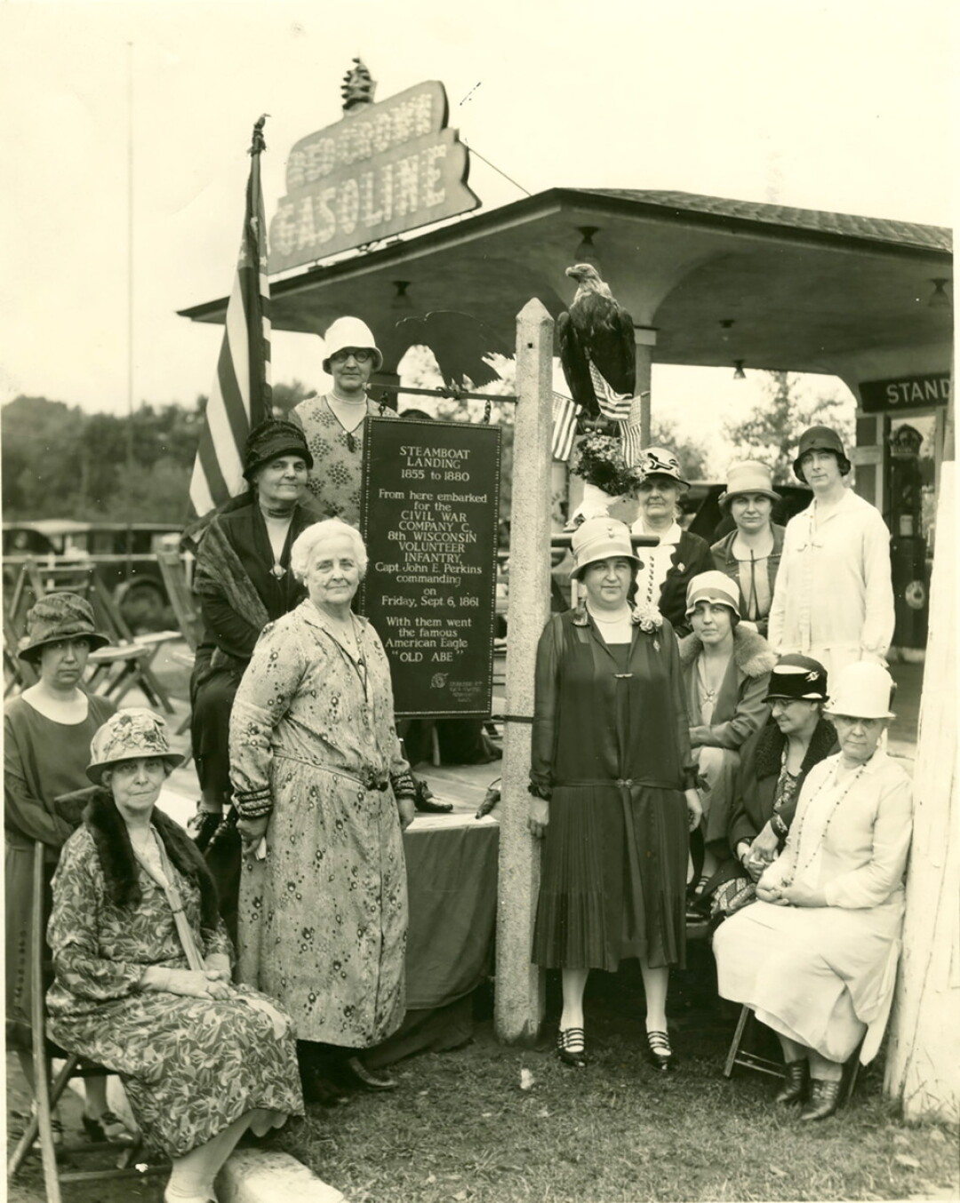 HAT’S OFF TO THEM. Members of the Eau Claire Chapter of the Daughters of the American Revolution gathered to dedicate a historical marker at the Gray Street steamboat landing in 1927 (top) and during a 2018 meeting.
