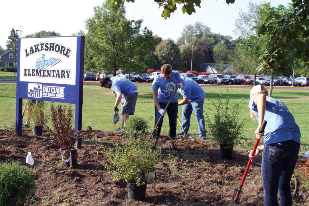 PITCHING IN. During last year’s Day of Caring, volunteers landscaped at Lakeshore Elementary, painted for the Lowes Creek Little League (below), and helped out Habitat for Humanity (further below).