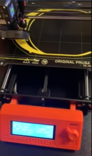 A protective mask visor being created by one of the Pablo Center's 3D printers.