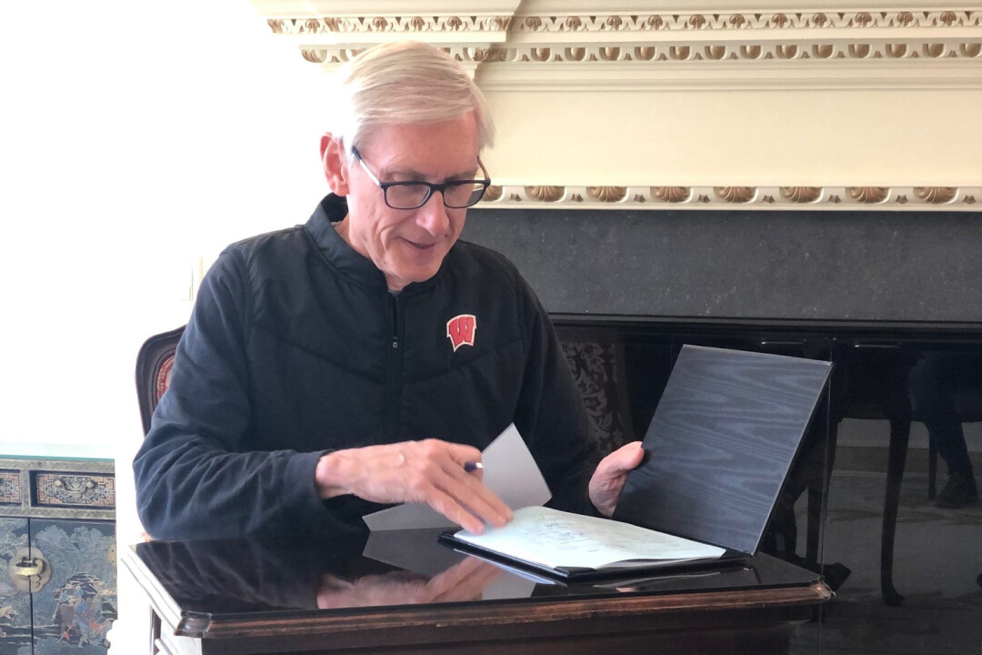 Wisconsin Gov. Tony Evers signs COVID-19 legislation on April 15, 2020.