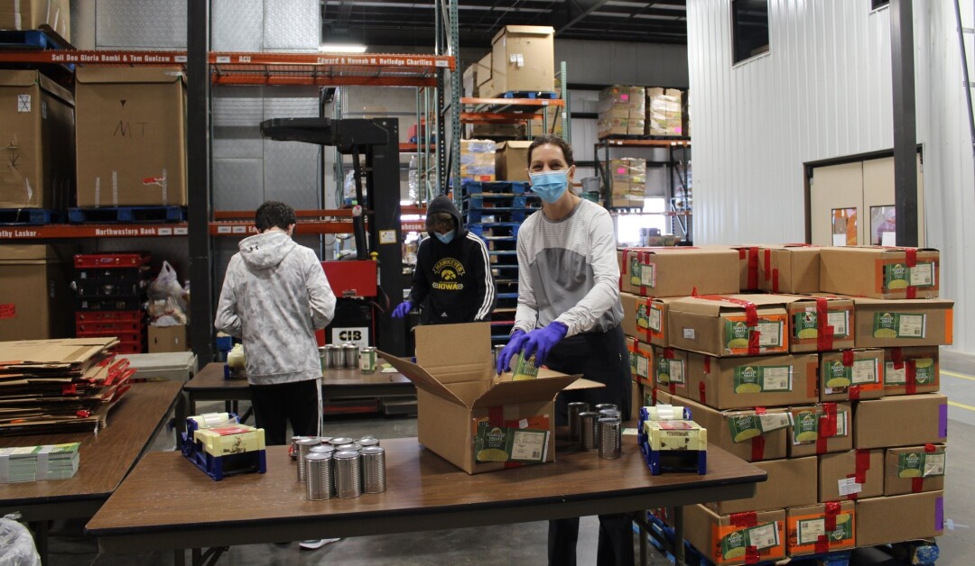 Volunteers pack emergency food distribution boxes at Feed My People Food Bank in Eau Claire. (Source: Facebook)