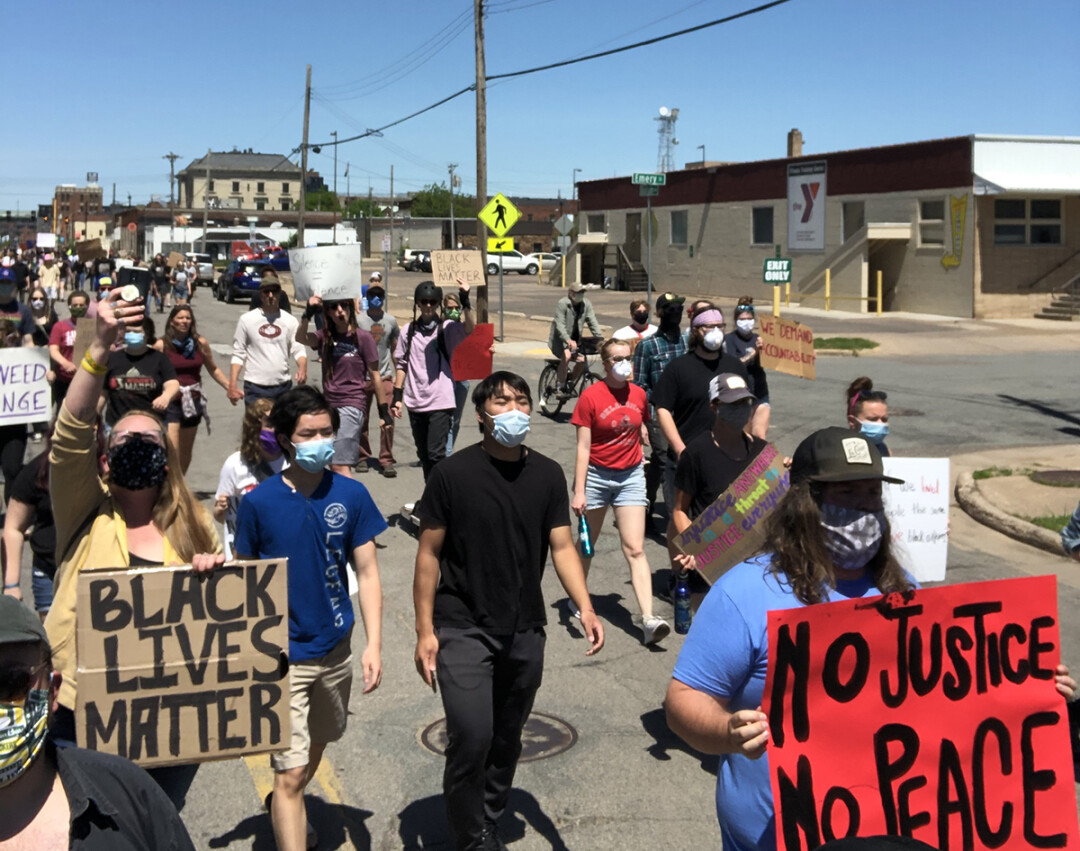 Demonstrators march down Graham Avenue in Eau Claire on Sunday, May 31.