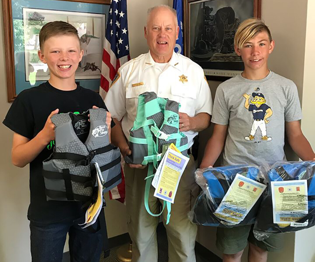 Making a donation of life jackets to the Chippewa County Sheriff’s Department.
