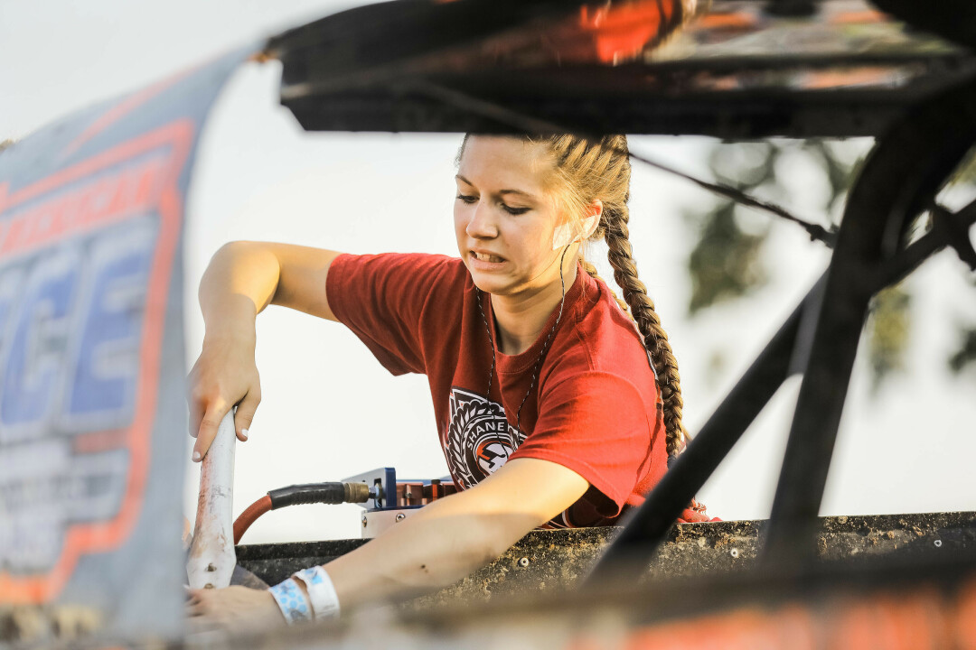 DOING CHORES? NO THANKS. One of the biggest tasks in caring for her race car is cleaning up the vehicle after a dirt race. (Photo by Andrea Paulseth)