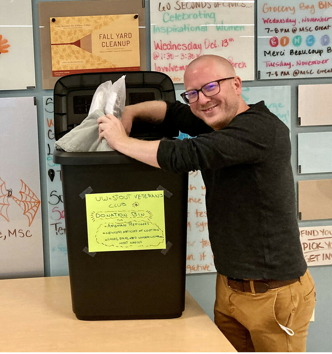 Veterans Club President Eric Gritzmacher collects items donated to help Afghan evacuees at one of two bins in the UW-Stout Memorial Student Center. The university Veterans Club is sponsoring the drive to collect new or like new clothing until Monday, Nov. 8.