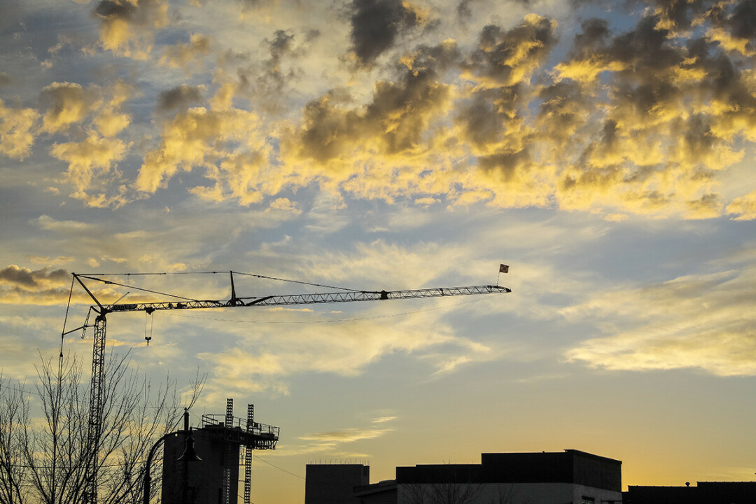 Construction cranes like this one, photographed in late 2021, have dominated the downtown Eau Claire skyline over the past year.