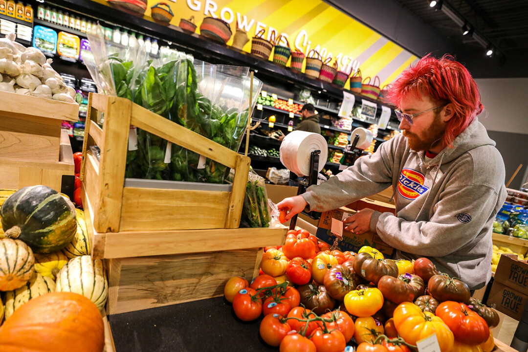 EAT YOUR COLORS. Workers stocked shelves on Tuesday, Oct. 10, at the soon-to-open Menomonie Market Food Co-op in downtown Eau Claire.