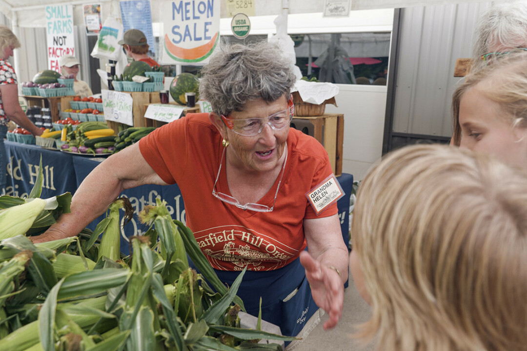 Helen Kees of Wheatfield Hill Organics in Durand talks with some young friends at a market she hosted on her farm