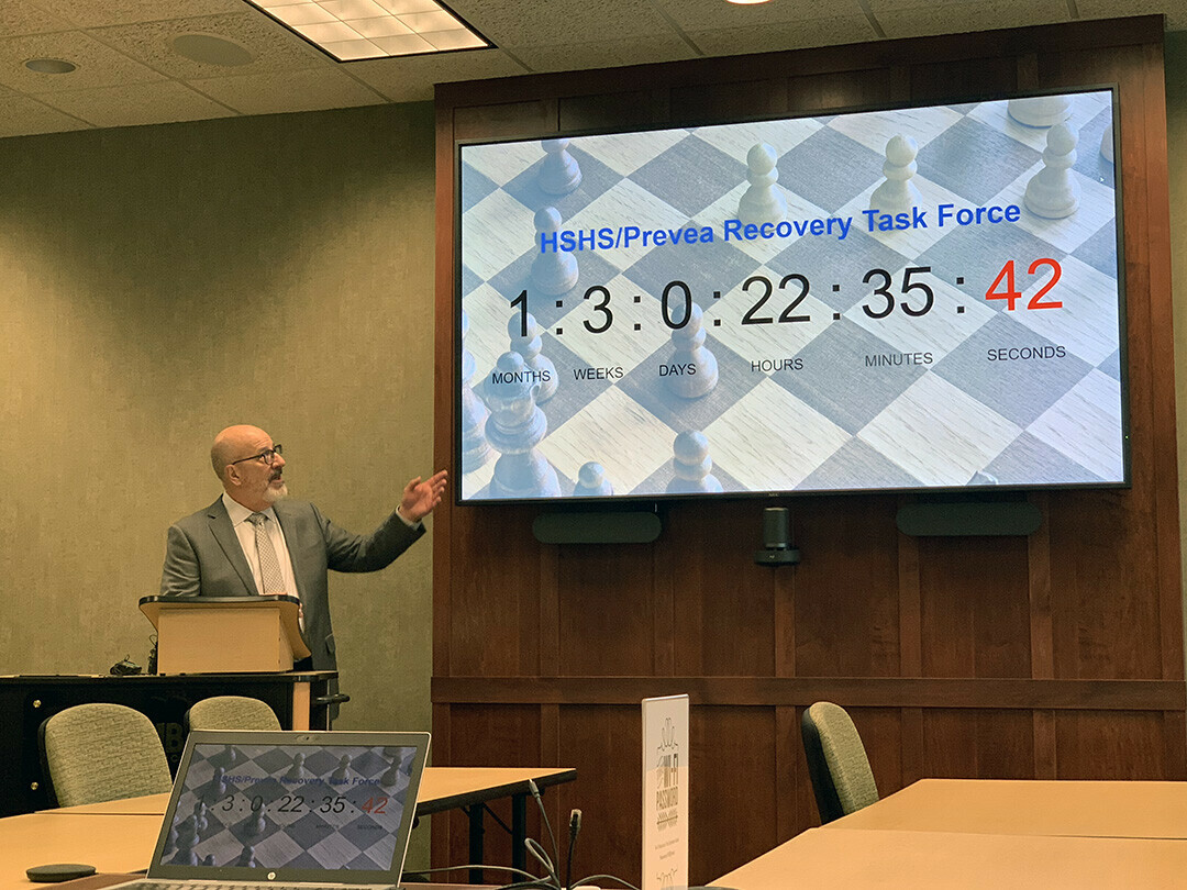David Minor, CEO and president of the Eau Claire Area Chamber of Commerce, points to a screen that shows how long the task force formed to deal with the Chippewa Valley's healthcare facility shudowns has 