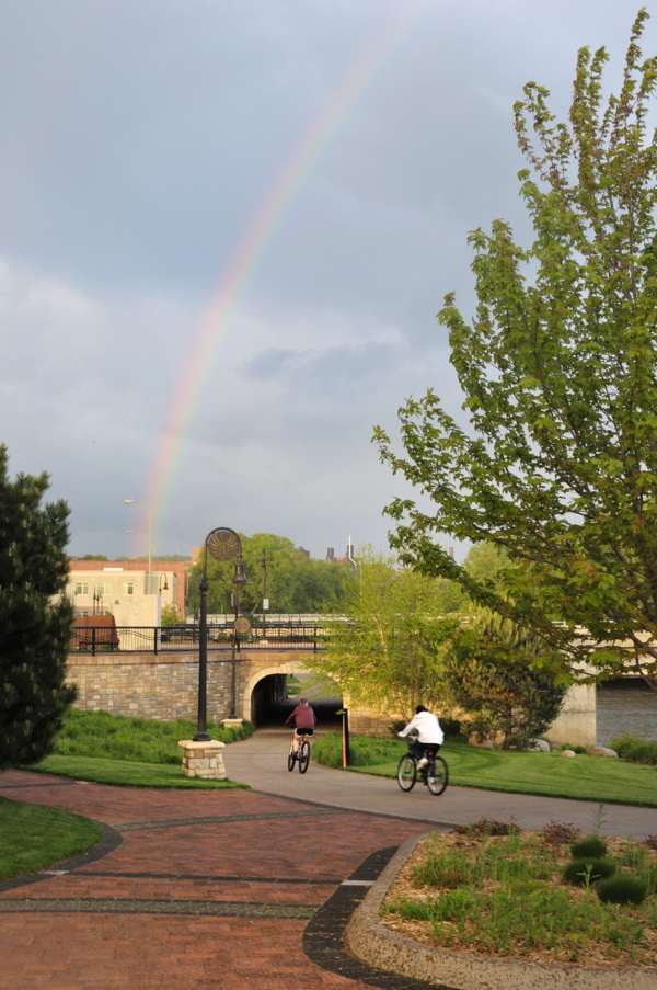 Local youths, shown here en route to a pot of gold. A rainbow bursts skyward, as seen from Phoenix Park in downtown Eau Claire, immediately following evening downpours on Tuesday, May 8.