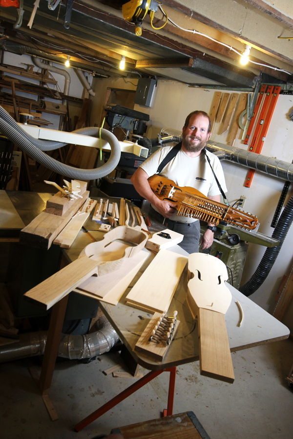 Earl Holzman holds one of his handmade “nyckelharpas,” a 16-string instrument dating back to the late 1600s.
