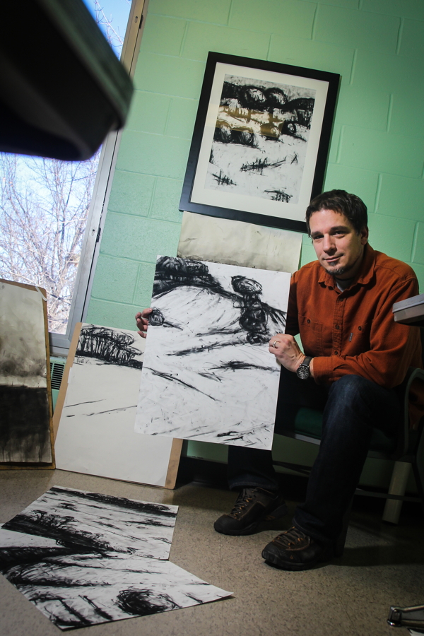 COAL PLUS SOUL. Artist David Brock displays some of his charcoal drawings in his office at UW-Eau Claire. His work will be on display at the Volume One Gallery March 6-April 24.