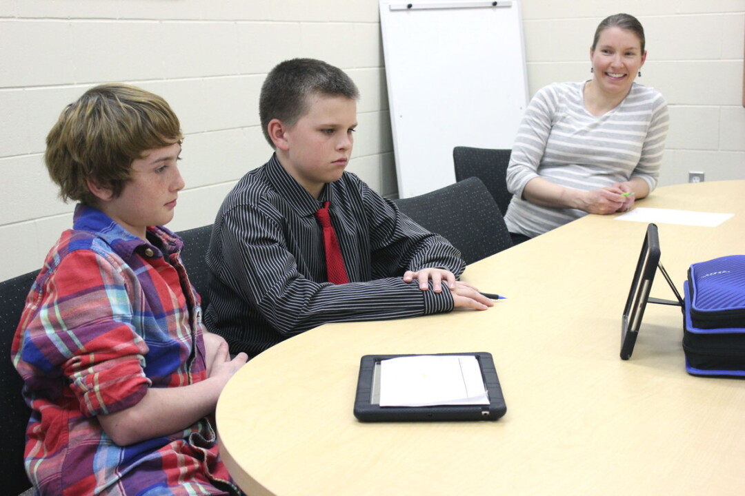 DeLong Middle School students Cody Welker, left, and Jonah Hanson conducted an interview for the Remarkable People project while teacher and project coordinator Bridget Smylie looked on.